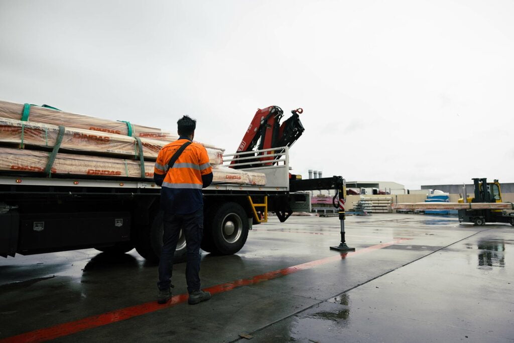 man overseeing a load being secured