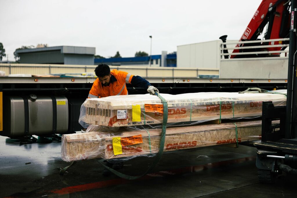 man securing a load on a forklift