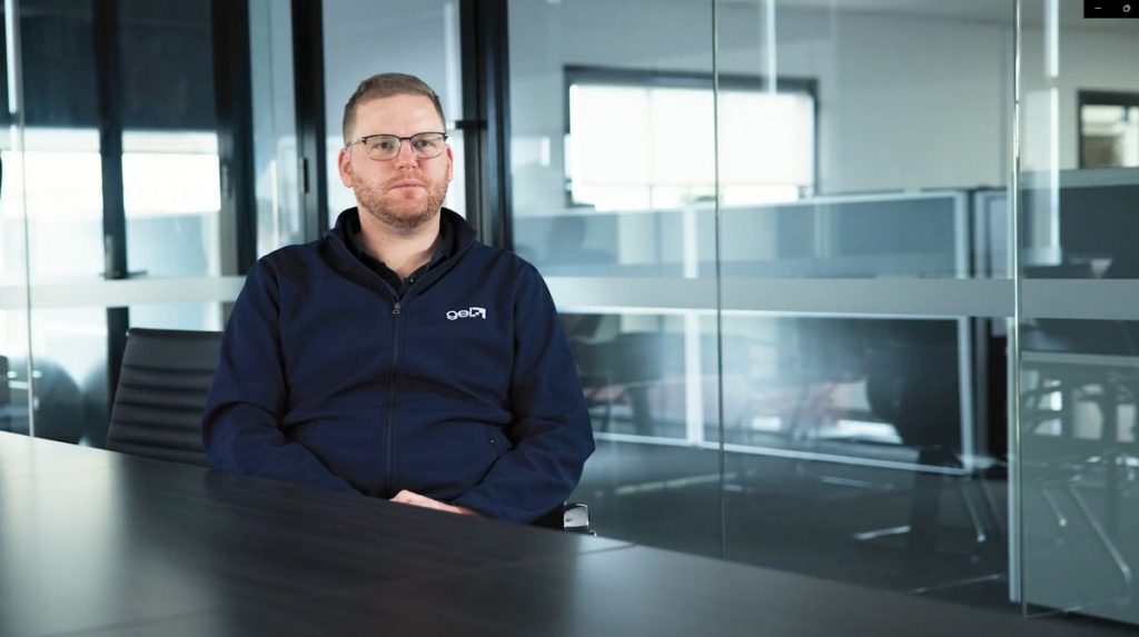 GEL Manager seated in an office discussing working with Metro